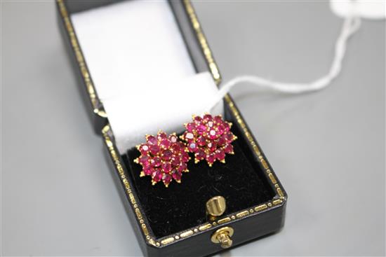 A pair of yellow metal and ruby cluster set flower head earrings, 13mm, gross weight 4.9 grams.